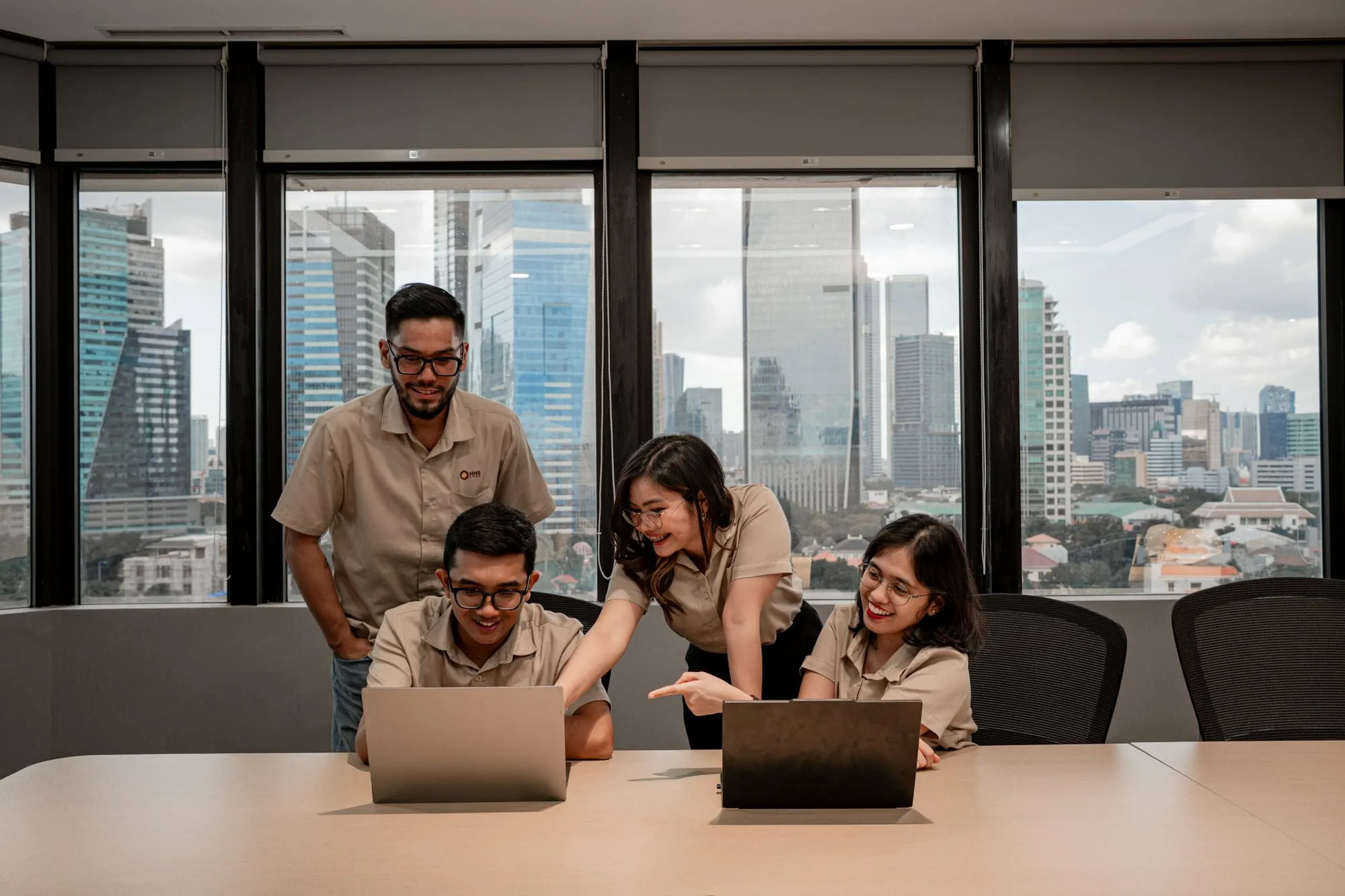 A team working together on laptops in a bright, modern office